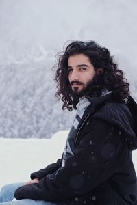 Portrait of young man in snow