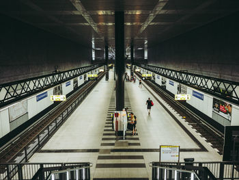 People walking on railroad station platform