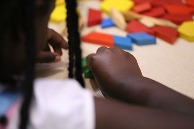 Close-up midsection girl playing with toy blocks on table