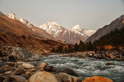 Scenic view of snowcapped mountains against clear sky