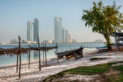 Scenic view of sea by city against clear sky