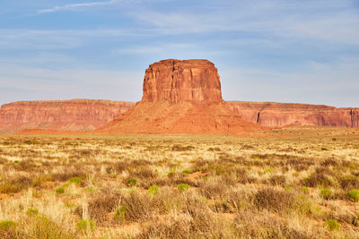 Rock formations on landscape against sky