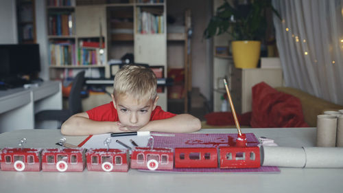 Boy playing with toy blocks at home