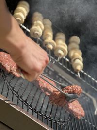 Cropped hand of man preparing food