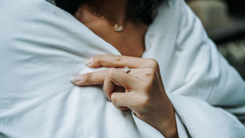 Midsection of couple kissing on bed