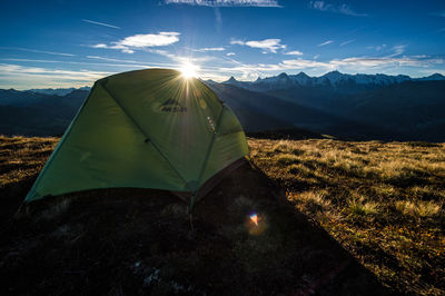 Aerial view of tent on field against mountains