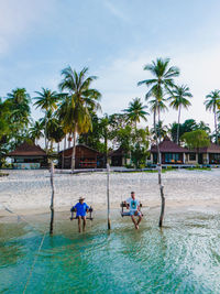 People on beach against sky