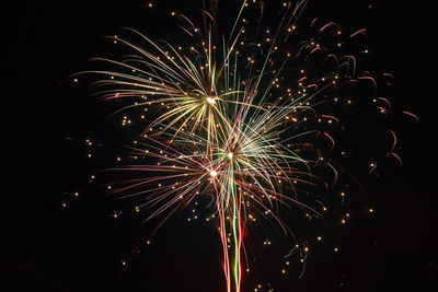 Low angle view of firework display at night