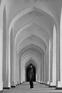 Side view of woman standing on archway