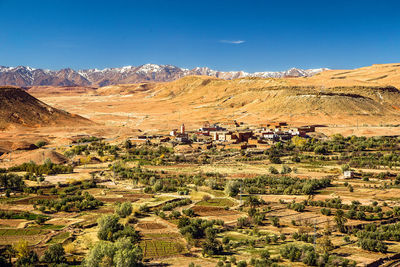 Scenic view of desert and atlas mountains against sky, morocco 