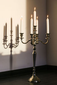 Candlestick holder by wall
