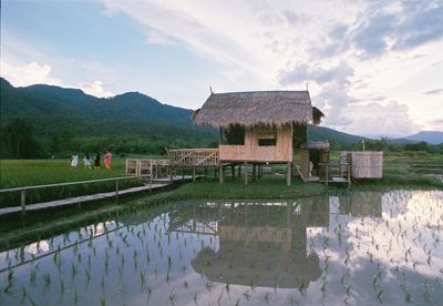 Reflection of building in lake against sky