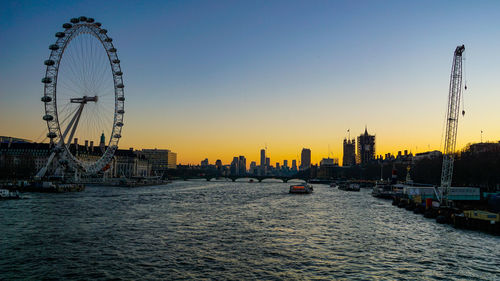Ferris wheel in city at sunset