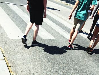 Low section of people walking on road