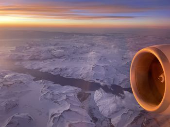 Aerial view of sea against sky during sunrise