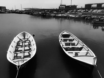 Boat moored at harbor against sky