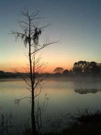 Scenic view of lake against sky at sunset