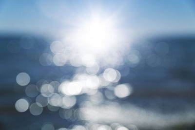 Defocused image of sea against sky on sunny day