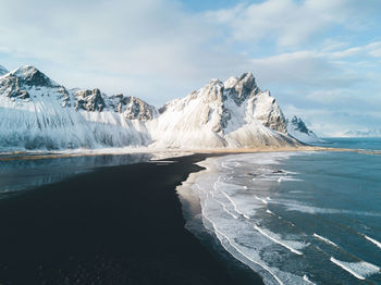 Scenic view of sea and mountains against sky