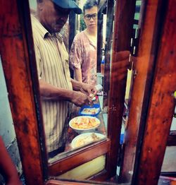 People standing by food