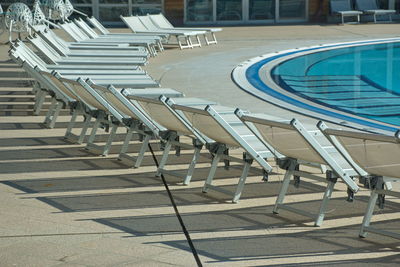 Outdoor swimming pool with chairs in hotel resort