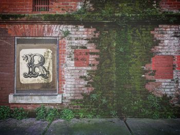 Close-up of text on brick wall