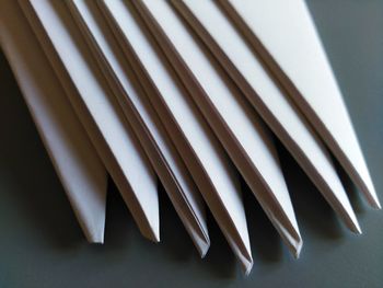 Close-up of folded white papers on table