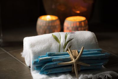 Close-up of towel with sticks and artificial starfish