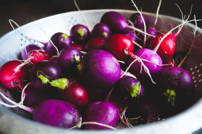 High angle view of radishes in vintage metal bowl