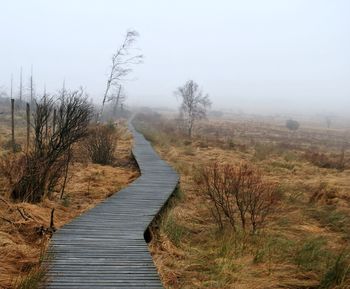 Scenic view of landscape against sky during winter