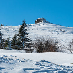 Scenic view of snowcapped mountains against clear blue sky