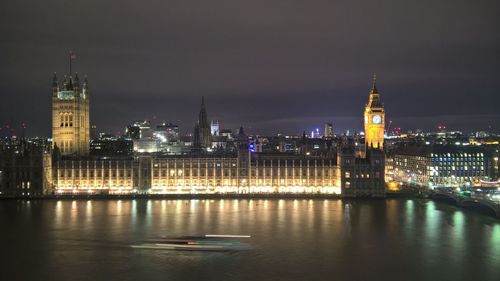 River with illuminated built structures in distance