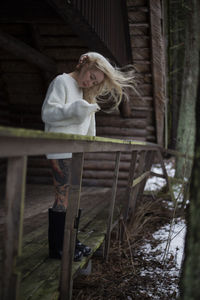 Rear view of young woman standing in forest