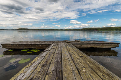 Pier over lake against sky