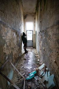 Full length of man standing in abandoned building