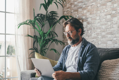 Young man using laptop at home