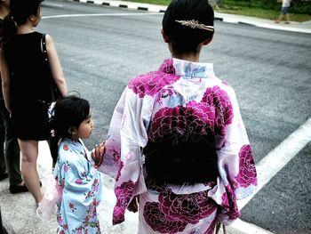 Rear view of girl standing outdoors