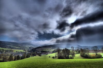 Scenic view of landscape against cloudy sky