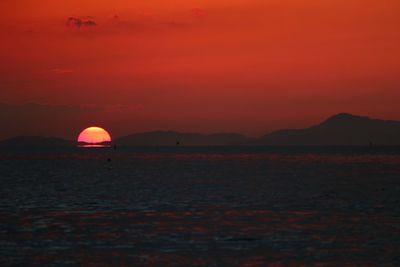 Scenic view of sea against romantic sky at sunset