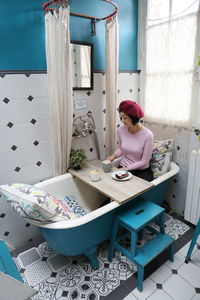 Young woman sitting on table