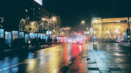 Illuminated city street at night