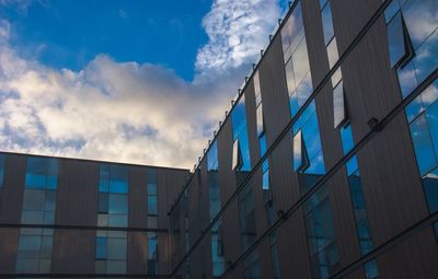 Low angle view of modern building against blue sky