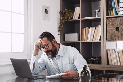 Man using laptop while sitting at home