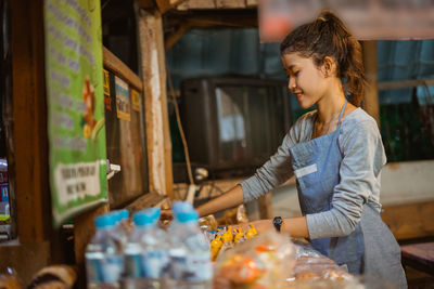 Side view of young woman looking away