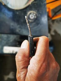 Close-up of hand holding metal