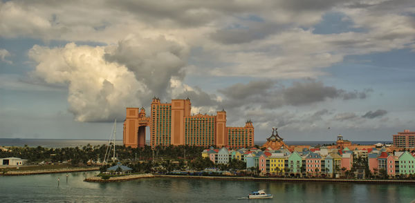 View of cityscape against cloudy sky