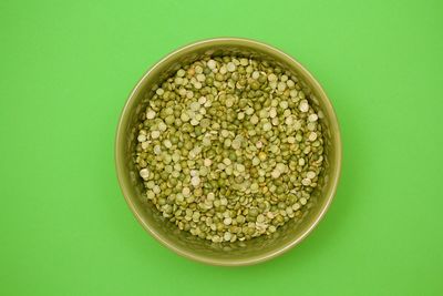 Directly above shot of soup in bowl against green background