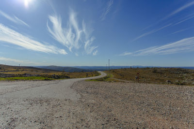 Road amidst landscape against sky