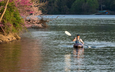 Man rowing boat in lake