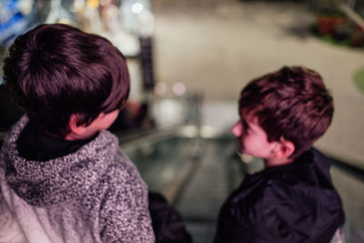 Defocused abstract of boys staring each other on a mechanical stair